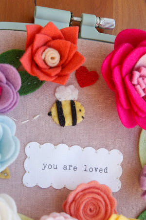 you are loved" original embroidered wall art with handmade felt flowers and bee